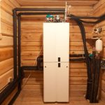 White refrigerator in rustic room with HVAC pipes, showcasing SOS Heating & Cooling's indoor air efficiency solutions.